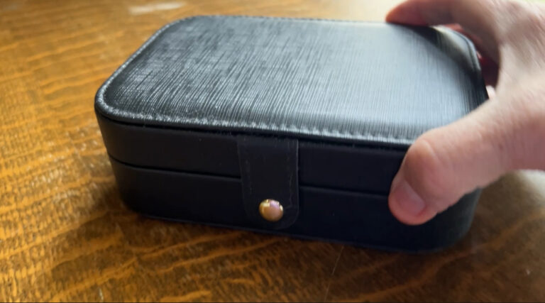 Small jewelry box with compartments for rings, earrings, and necklaces.