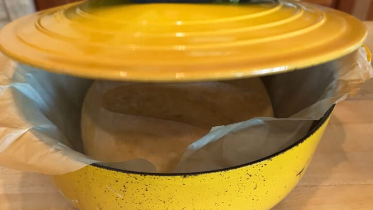 Le Creuset Dutch oven with freshly baked golden brown bread.