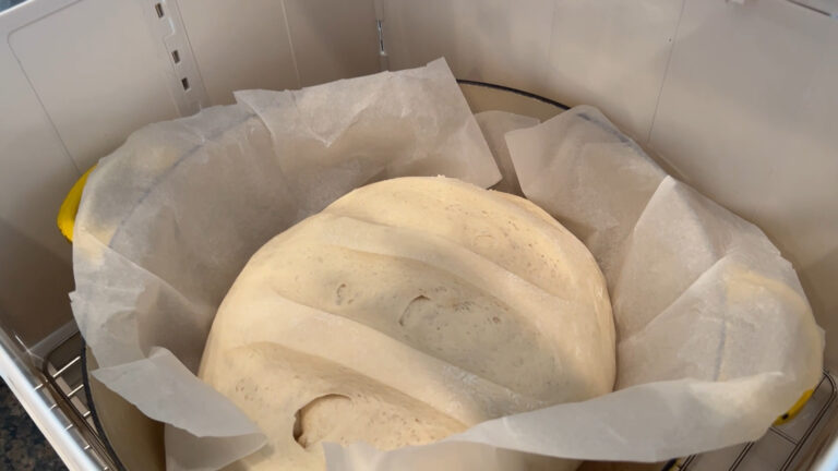 Folding bread proofer and slow cooker set up with pan inside.