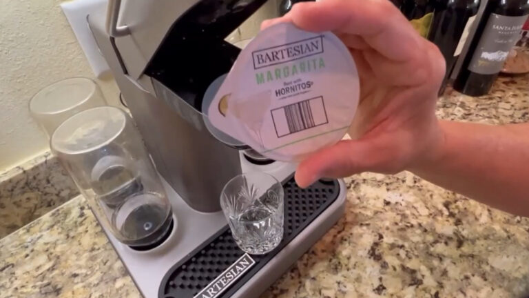 Bartesian cocktail maker on countertop with glass of margarita.