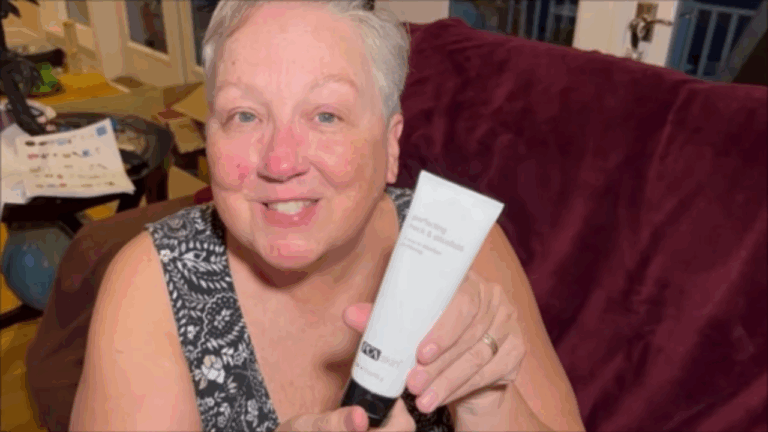PCA SKIN Perfecting Neck & Chest Firming Cream in white bottle on bathroom counter