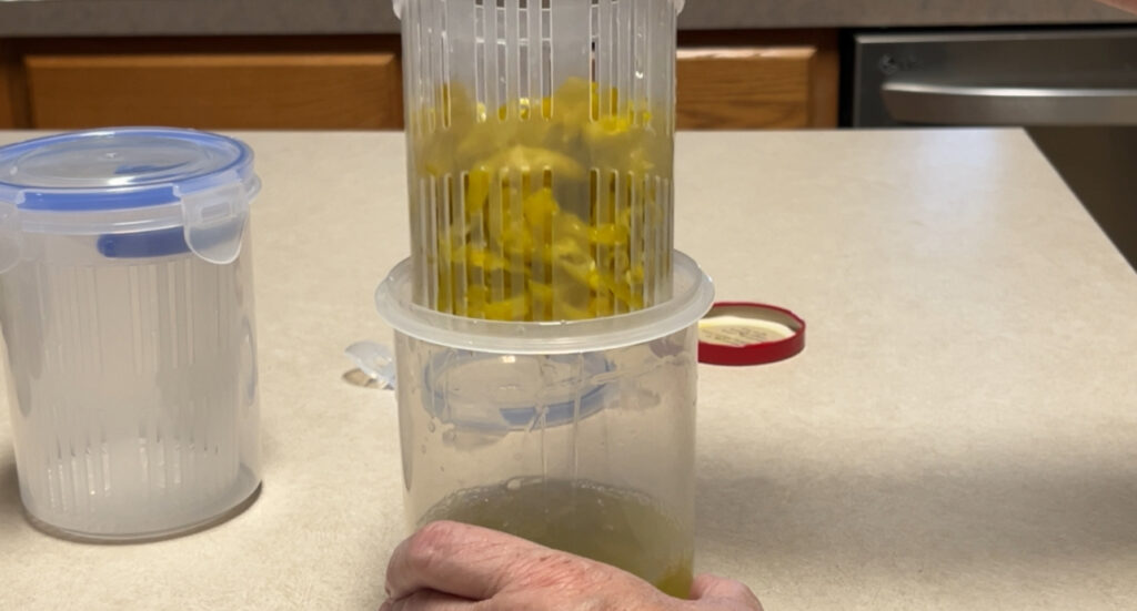 Pickle Basket being lifted out of juice 