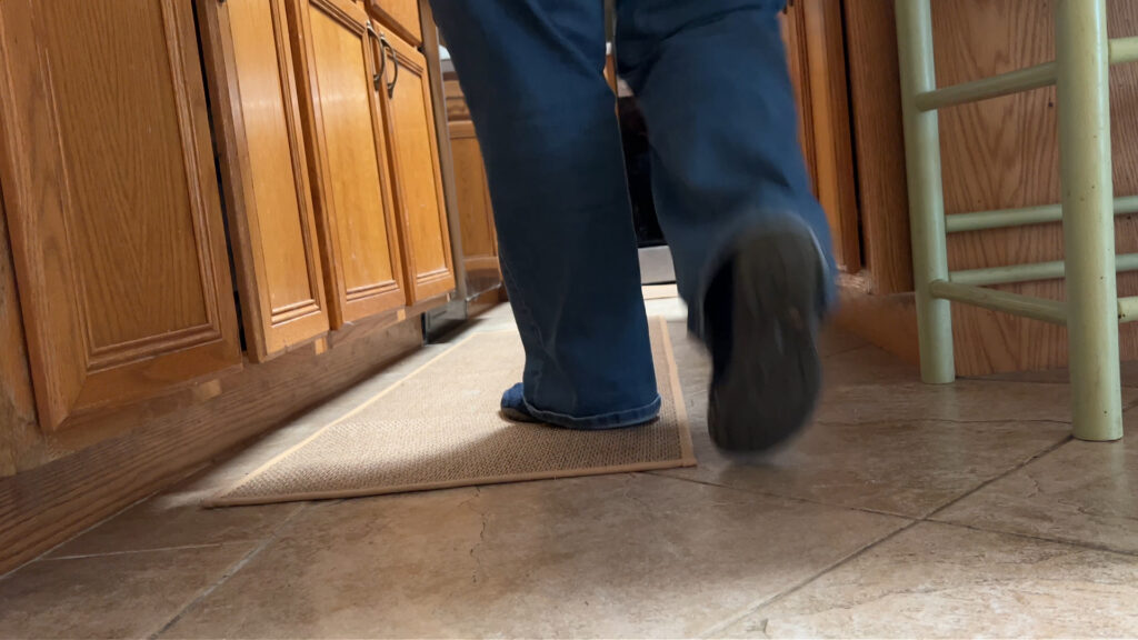 Two kitchen rugs placed in front of sink and stove in kitchen showing size and placement